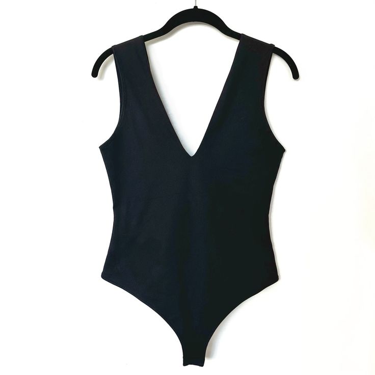 Pre-Loved. Unworn In Great Condition. Size M Self: 88% Nylon, 12% Spandex Lining: 92% Poly, 8% Spandex Mesh Lining Elasticized Trim Bottom Snap Button Closure Stretch V-neck Bodysuit For Workout, Black Stretch Bodysuit With Seamless Construction, Summer V-neck Elastane Bodysuit, V-neck Elastane Bodysuit For Summer, Black Casual Bodysuit With Seamless Construction, Casual Black Bodysuit With Seamless Construction, Casual Black Seamless Bodysuit, Sleek Black Bodysuit For Workout, Black V-neck Elastane Swimwear