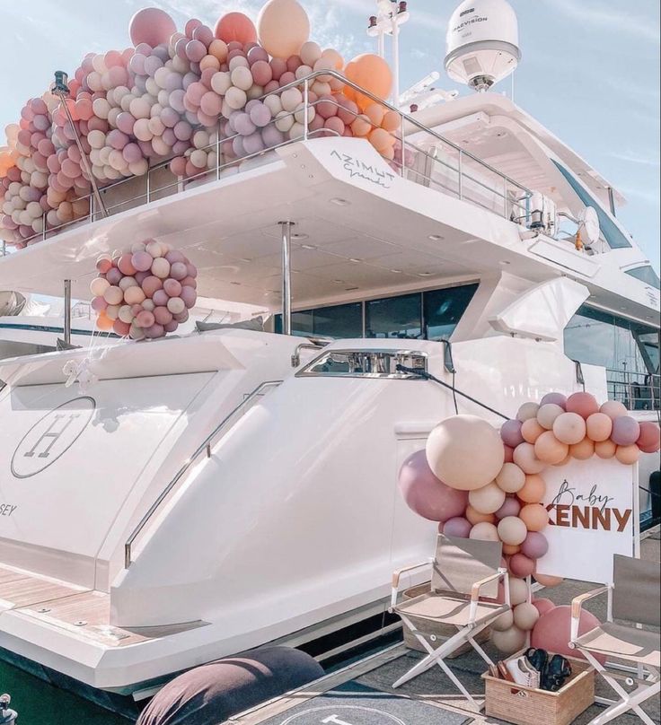 a large white boat with balloons attached to it