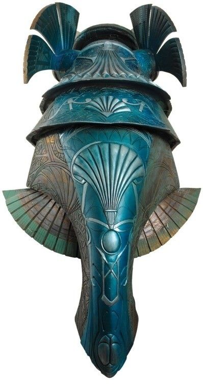 an elephant's head is painted in blue and green colors, with large horns on it