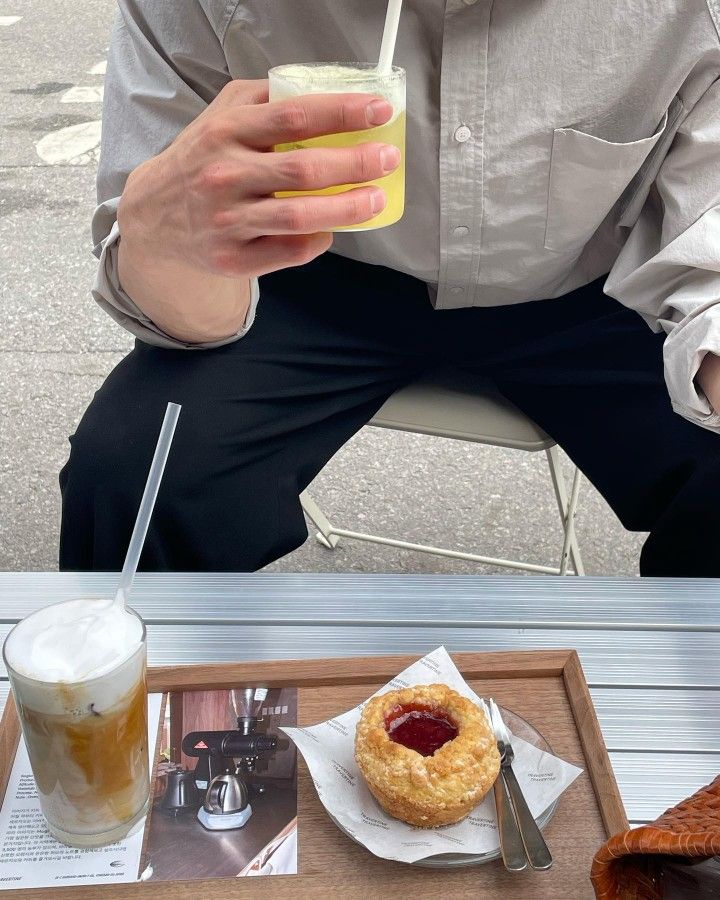 a man sitting at a table with food and drinks