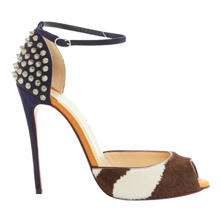 CHRISTIAN LOUBOUTIN Pina Spike animal peep toe ankle strap studded heel EU37.5 Reference: TGAS/A02537 Brand: Christian Louboutin Model: Pina Spike 120 Material: Leather Color: Multicolour Pattern: Animal Print Closure: Ankle Strap Extra Details: Pina Spike 120. Brown and white animal print calfskin. Peep toe. Orange satin lining. Navy blue suede leather heel. Covered heel. Silver tone spike studded heel. Ankle strap. Padded tan leather lining. Signature Louboutin red lacquered sole. Made in: Ita Italian Boots, Louboutin High Heels, Orange Satin, Red Louboutin, Classy Shoes, Christian Louboutin Heels, Studded Heels, Italian Shoes, Spike Heels