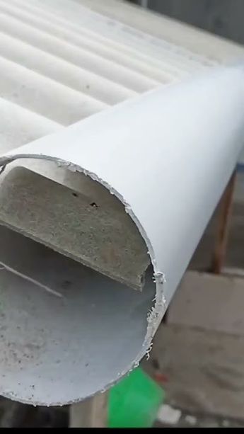 a close up of a white pipe on the ground