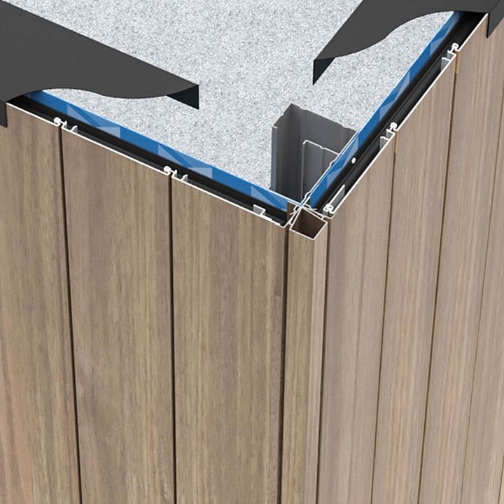 the corner of a wooden building with metal brackets