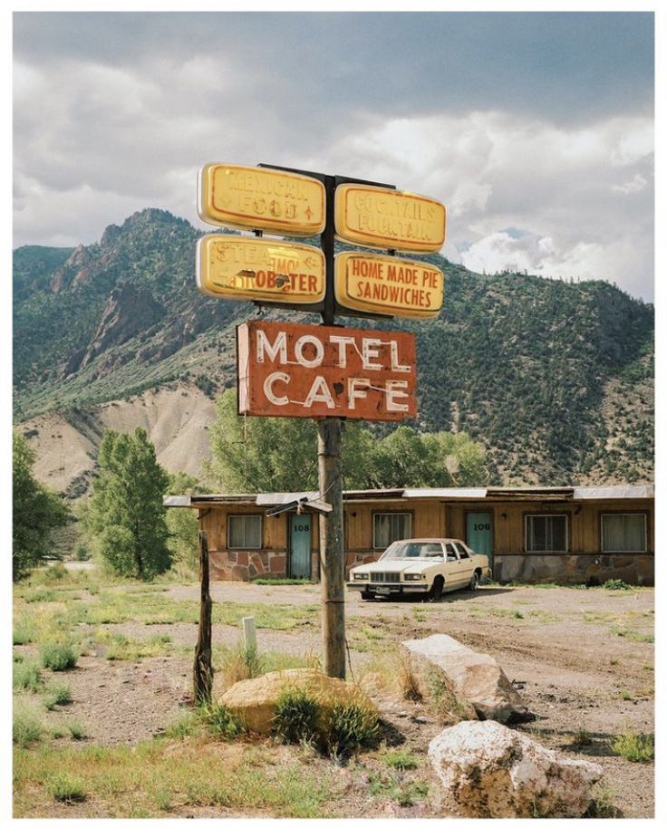 an old motel sign in the middle of nowhere