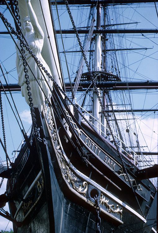 an old sailing ship with a statue on the front