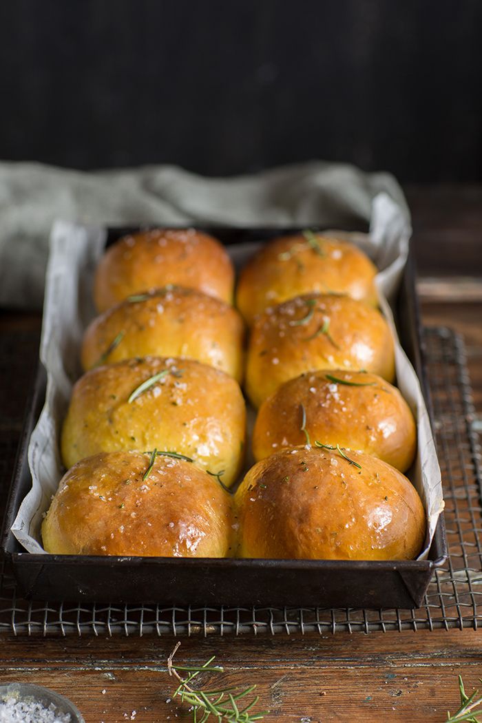 several rolls in a baking pan on a cooling rack