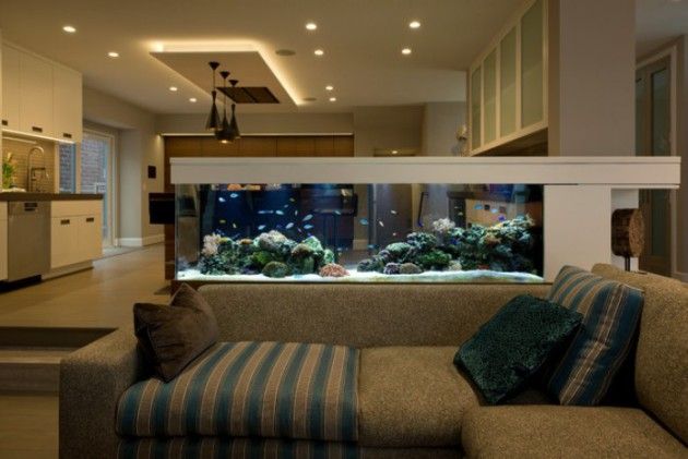 a living room filled with furniture and an aquarium in the middle of it's wall