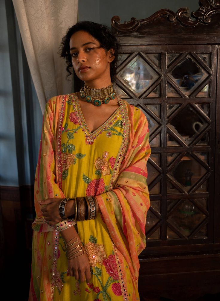 Editor's Note Introducing a captivating multi-printed kurta set featuring panels adorned with floral and stripe highlights. Paired with dyed pants and a beautifully printed dupatta, this ensemble exudes a vibrant and stylish appeal. The combination of different prints adds an element of visual interest, making it a standout choice. Step into any occasion with confidence, embracing the beauty and versatility of this multi-printed kurta set. Color: Yellow Fabric: Kurta: malie chanderi, pants: cott Transitional Multicolor Sharara With Dabka Detail, Yellow Palazzo Set With Dabka For Navratri, Yellow Dabka Palazzo Set For Navratri, Transitional Multicolor Sharara With Dabka, Navratri Yellow Dabka Palazzo Set, Transitional Multicolor Dabka Sharara, Yellow Chanderi Lehenga With Dabka Detailing, Designer Yellow Lehenga With Dabka Embroidery, Designer Yellow Lehenga With Dabka Detail