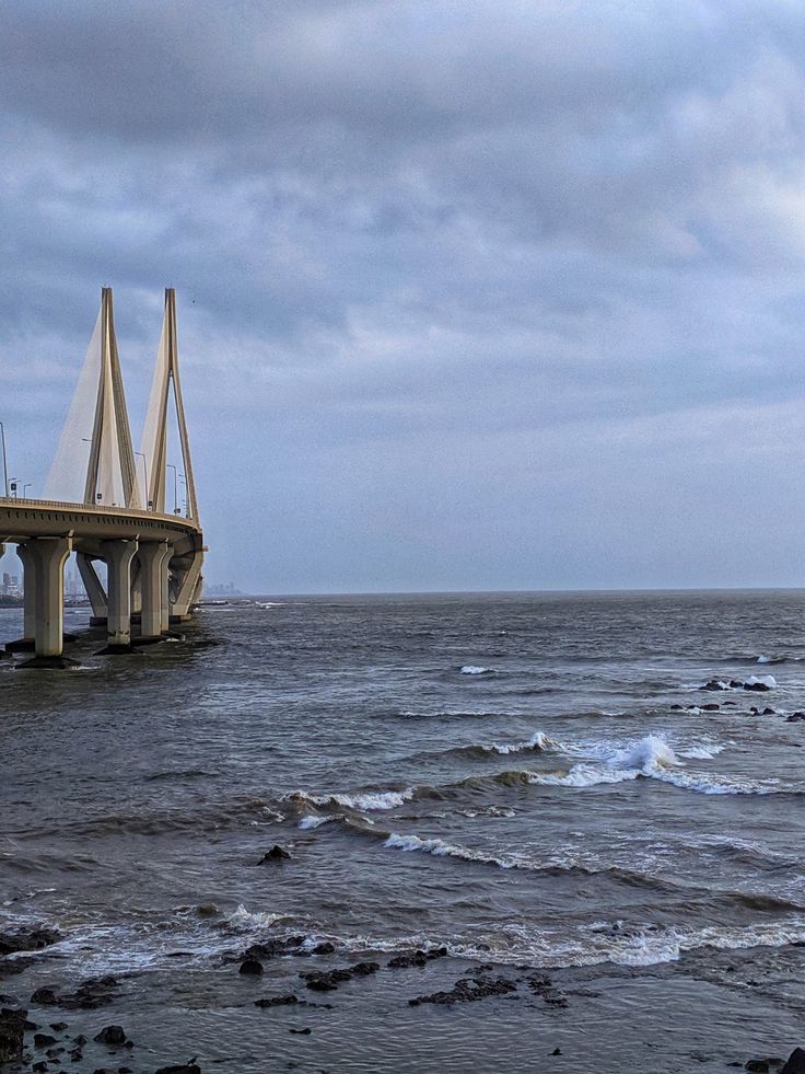 a bridge over the ocean on a cloudy day