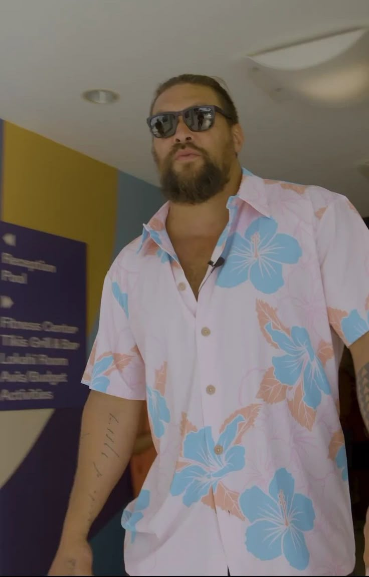 a man wearing sunglasses and a hawaiian shirt