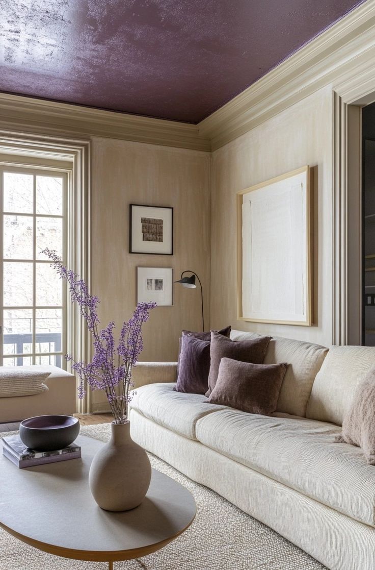 a living room filled with furniture and a purple ceiling painted in the same color as the walls