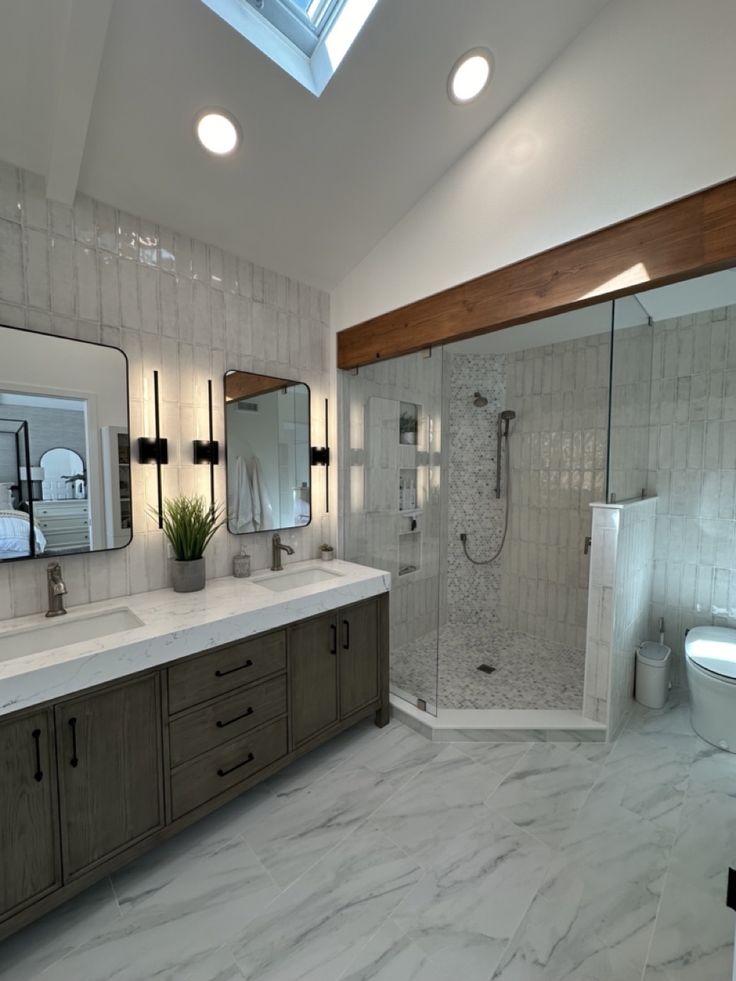 a large bathroom with two sinks and a shower