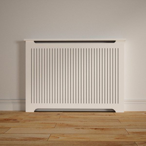 a white radiator sitting on top of a wooden floor next to a wall