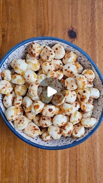 a blue bowl filled with food on top of a wooden table