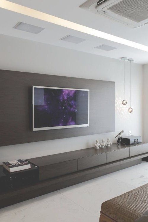 a large flat screen tv mounted to the side of a wall in a living room