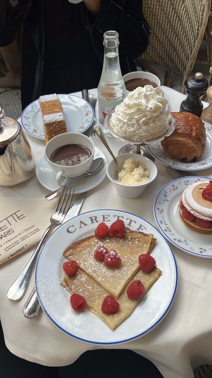 a table topped with pancakes and other desserts