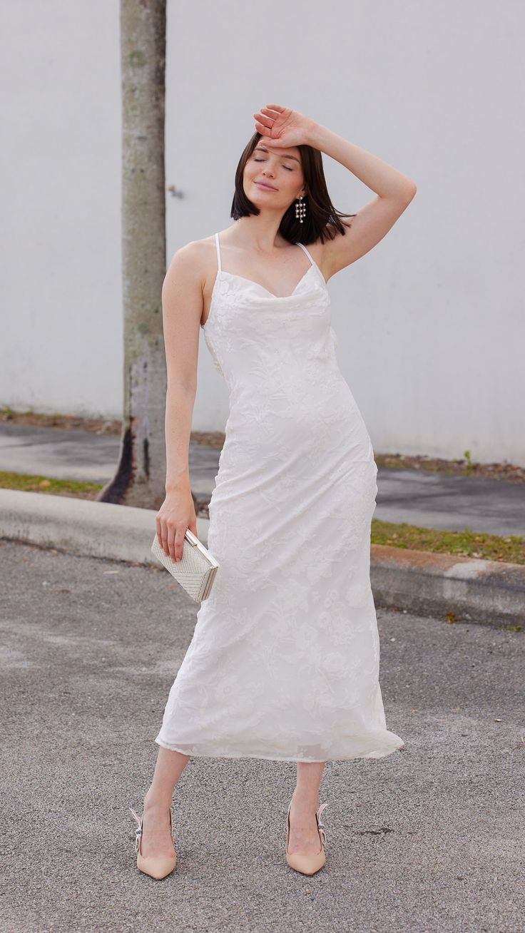 Indulge in the epitome of elegance with this delicate cowl neck midi dress adorned with a mesmerizing floral white design. Effortlessly chic, the cowl neckline drapes gracefully, while the midi length exudes sophistication. Features: Midi Cowl Neck Floral White Fabric Model is wearing a small 78956 Elegant Party Midi Dress With Cowl Neck, Elegant Spring Dress With Cowl Neck, Spring Formal Maxi Dress With Cowl Neck, Elegant Cowl Neck Midi Dress For Summer, Elegant Midi Dress With Cowl Neck, Elegant Cowl Neck Midi Dress For Date Night, Elegant Cowl Neck Dress For Date Night, Elegant Midi Dress With Cowl Neck For Formal Occasions, Cowl Neck Midi Dress