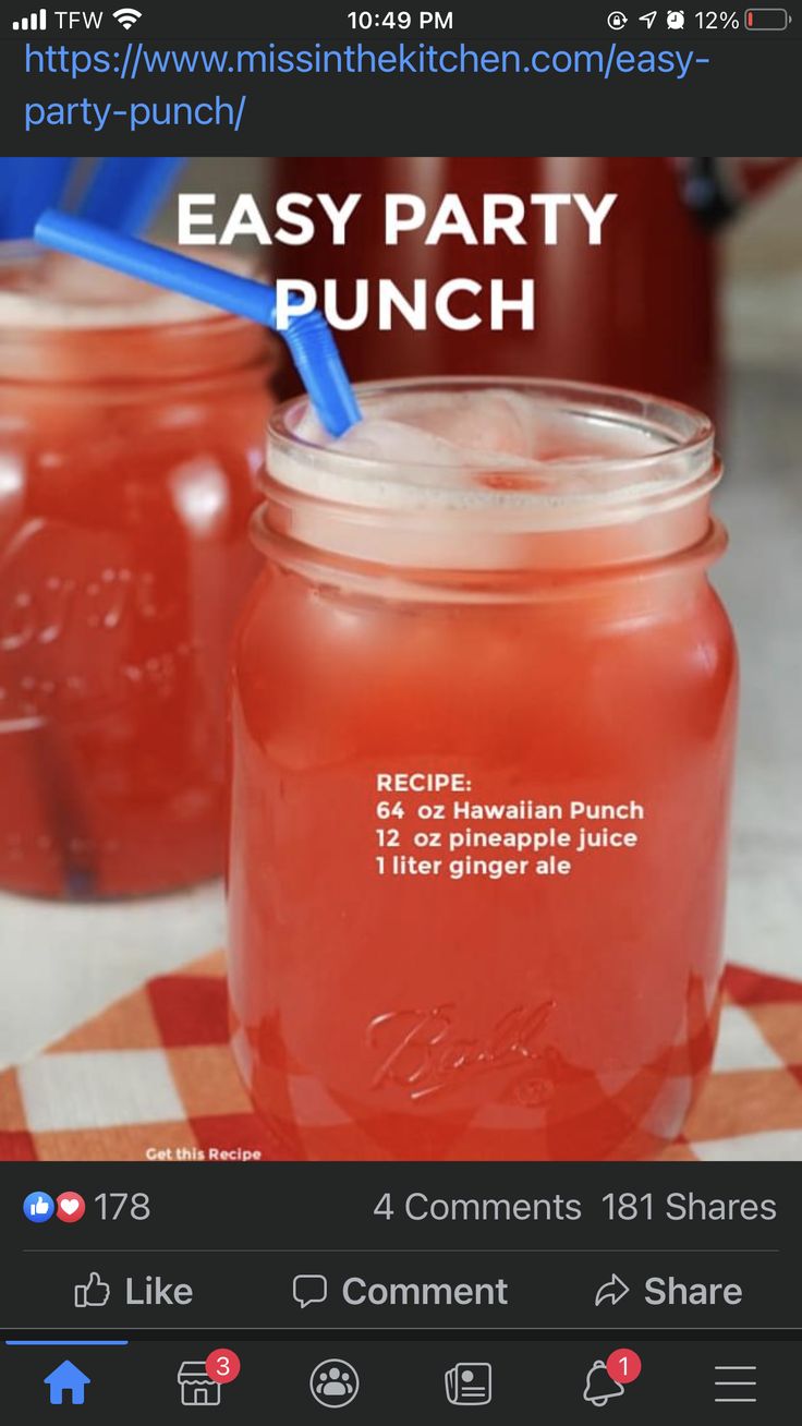 two mason jars filled with red liquid and blue straws are sitting on a checkered table