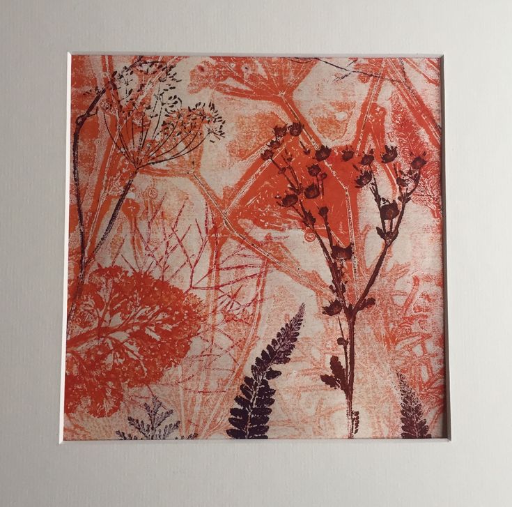 an orange and red painting with flowers on it