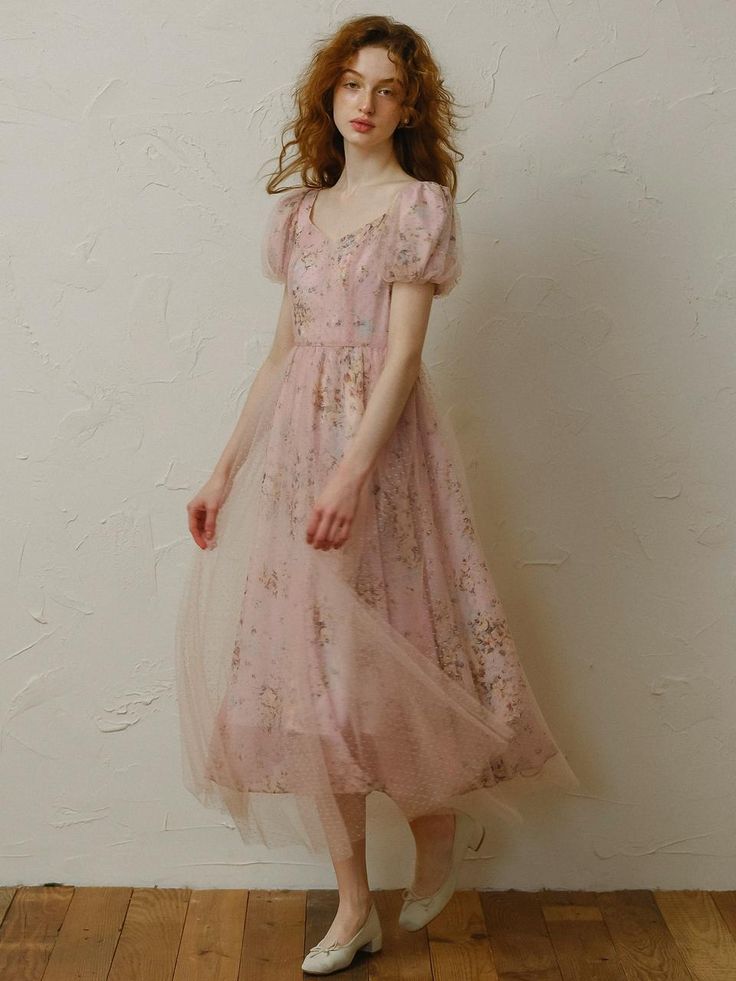 This product is a delicate and charming dress designed to bring a touch of fairy-tale elegance to your wardrobe. It features intricate floral patterns overlaid with a soft mesh fabric, creating a dreamy and ethereal look. The dress is tailored to enhance your feminine silhouette while ensuring comfort and grace for any special occasion. - This dress boasts a soft mesh overlay that adds a whimsical touch to the overall design.- The floral patterns are intricately detailed, offering a timeless and elegant appeal.- It is designed with a flattering silhouette that accentuates the waist and flows gracefully down to the hem.- Perfect for special occasions, this dress ensures both style and comfort with its high-quality fabric and exquisite craftsmanship. Balletcore Floral Print Dress For Garden Party, Dreamy Fitted Spring Dress, Ethereal Fairy Dress For Spring, Elegant Floral Print Tulle Dress, Elegant Tulle Dress With Floral Print, Organza Dress With Floral Print For Evening, Sheer Ethereal Spring Dresses, Ethereal Sheer Dresses For Spring, Spring Lace Fairy Dress