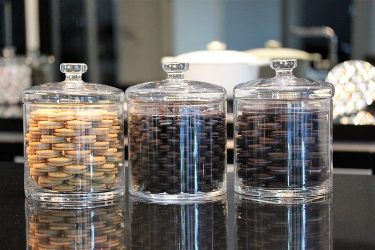 three glass containers filled with different types of cookies