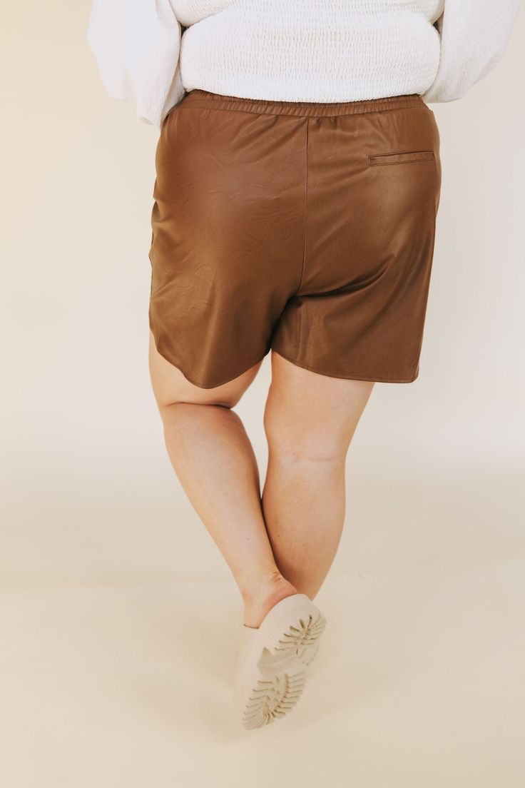 Take your style to the next level with these PLUS SIZE City Life Shorts! Crafted from brown faux leather, these fab shorts feature an elastic waistband with adjustable tie for an unbeatable fit and two handy pockets so you can always keep your essentials close by. Let's get this party started! Details Faux leather material Pockets! Elastic waistband Adjustable tie waist Back pocket is non-functioning Sizing Approximate measurements: SIZE LENGTH WAIST INSEAM 1XL 17” 36” 4” 2XL 17.5” 38” 4” 3XL 18 Casual Faux Leather Shorts, Summer Brown Faux Leather Bottoms, Brown Leather Summer Bottoms, Brown Faux Leather Short Bottoms, Brown Leather Shorts For Spring, Brown Faux Leather Shorts For Spring, Spring Leather Brown Shorts, Spring Brown Leather Shorts, Brown Short Bottoms With Elastic Waistband