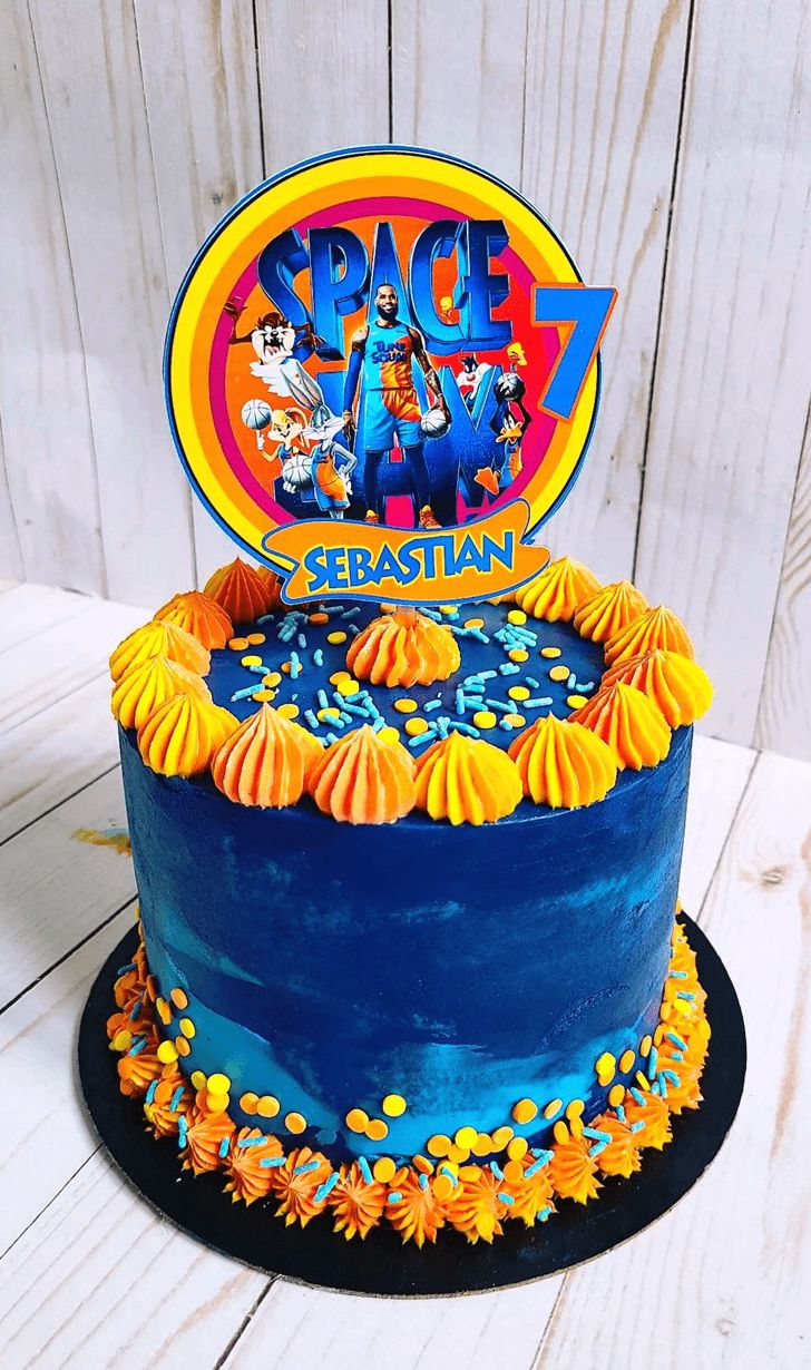 a birthday cake decorated with an image of the space jam band on it's top