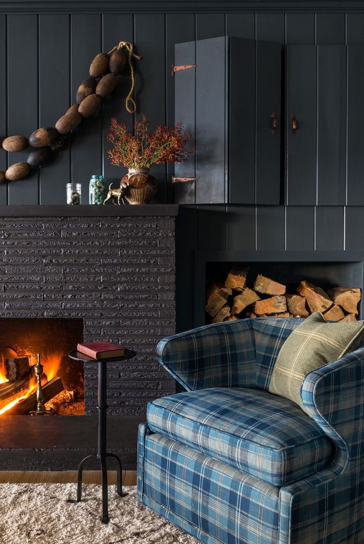 a living room filled with furniture and a fire place in front of a brick fireplace