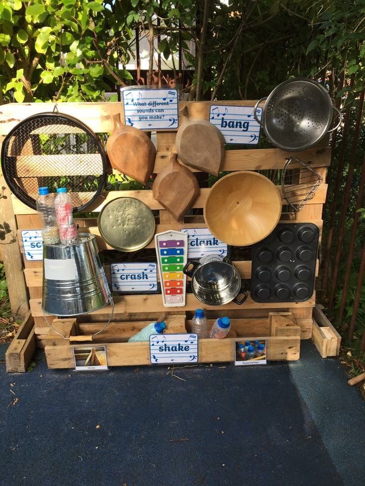 a wooden pallet with pots and pans on it's sides, including an egg carton