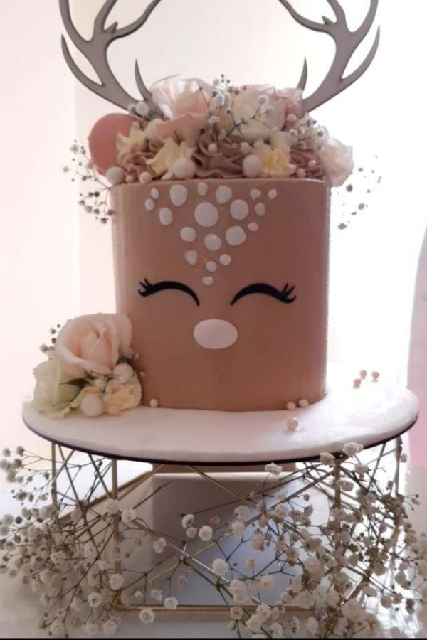 a cake with flowers and antlers on it