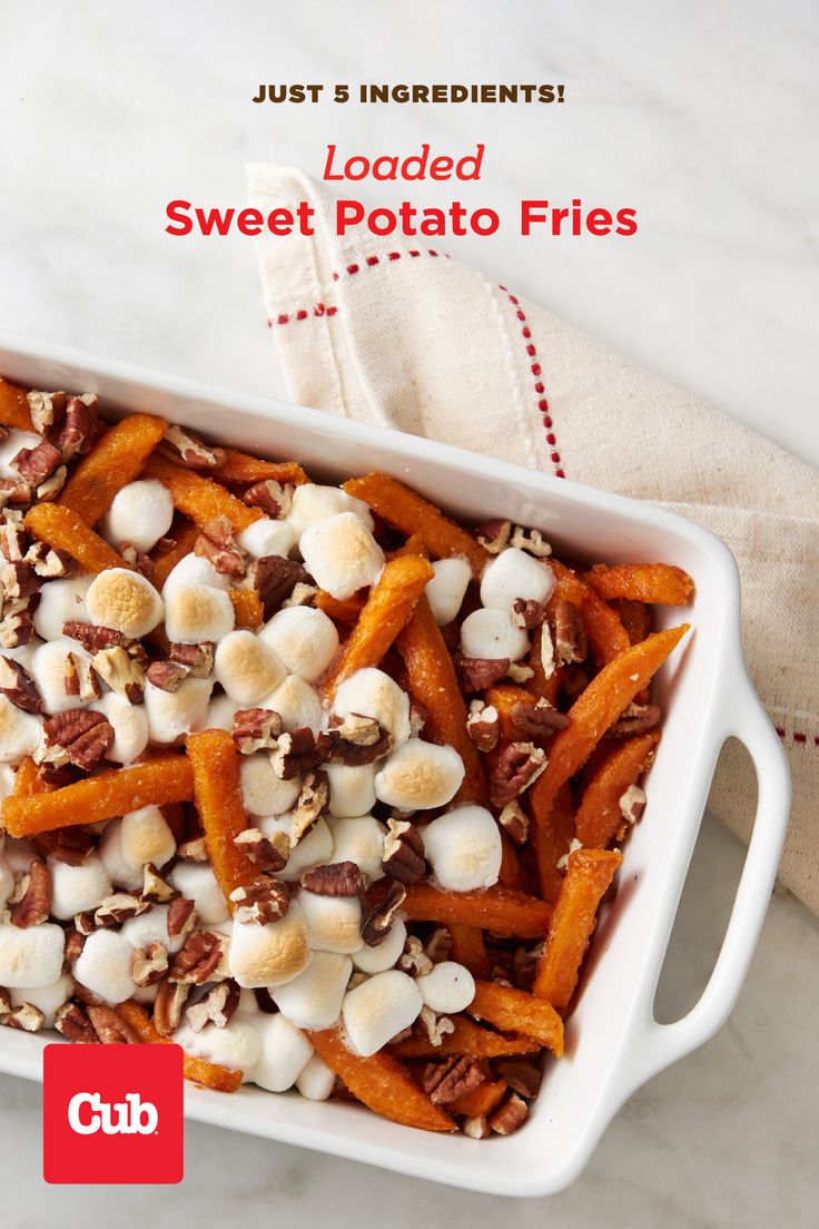 sweet potato fries are topped with nuts and marshmallows in a white casserole dish