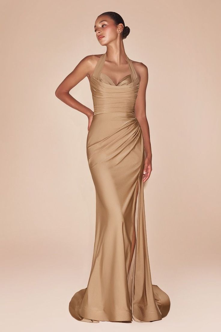 The Autumn Gown showcases a halter neckline, a gathered waist, and a stylish leg slit, creating an elegant silhouette. Crafted from stretch spandex satin, it ensures a flawless fit with a zip back closure. Perfect for bridesmaids, wedding guests, and formal occasions, this dress radiates sophistication. -Zip back closure -Ruched halter bodice -Fully lined -Fabric does have some stretch -Size Tip: Please use the attached size guide for sizing -Column silhouette and natural waistline -Occasions: I Satin Halter Dress, Stretch Satin Fabric, Stretch Satin Dress, Long Halter Dress, Colorful Dresses Formal, Cinderella Divine, 21st Dresses, Usa Dresses, Stunning Gowns