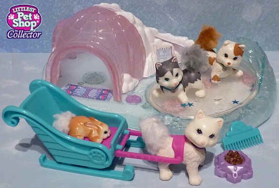 small toy animals are playing in a bathtub with toys like cats and dogs on it