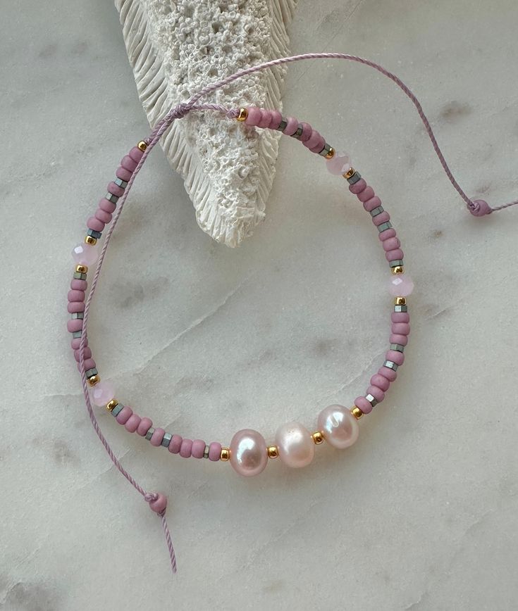 Pretty pink freshwater pearls, Japanese seed beads, metallic beads, gold seed beads pink crystals on a waxed thread, adjustable to fit most sizes. Pink Bohemian Beaded Bracelets Resizable, Pink Bohemian Beaded Bracelet, Resizable, Pink Bohemian Beaded Resizable Bracelet, Bohemian Pink Beaded Pearl Bracelet, Pink Resizable Friendship Bracelets With Round Beads, Bohemian Pink Beaded Bracelets With Sliding Knot, Pink Bohemian Beaded Bracelet With Sliding Knot, Bohemian Pink Pearl Bracelet For Jewelry Making, Pink Resizable Bracelets With Round Beads