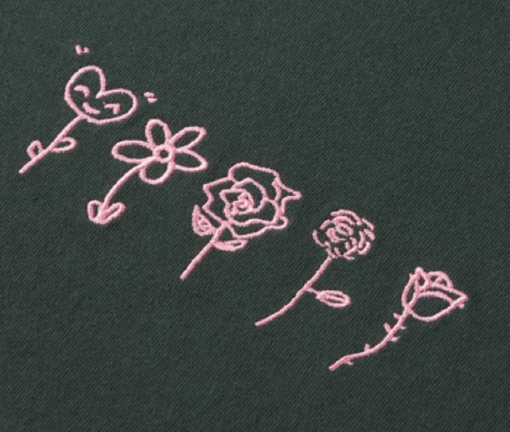 three pink flowers are drawn on a black t - shirt