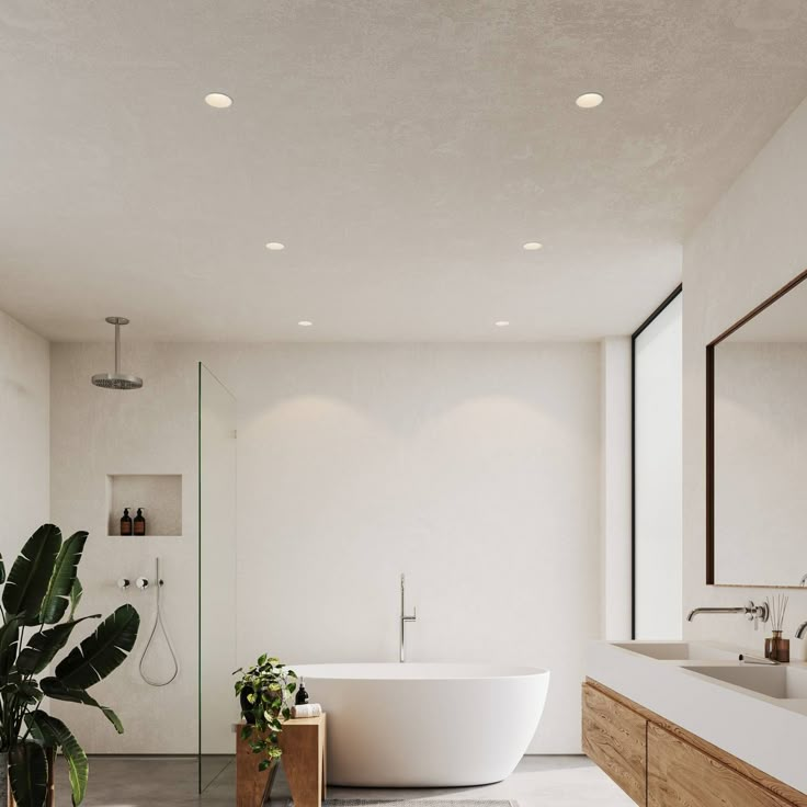 a large white bath tub sitting next to a bathroom sink