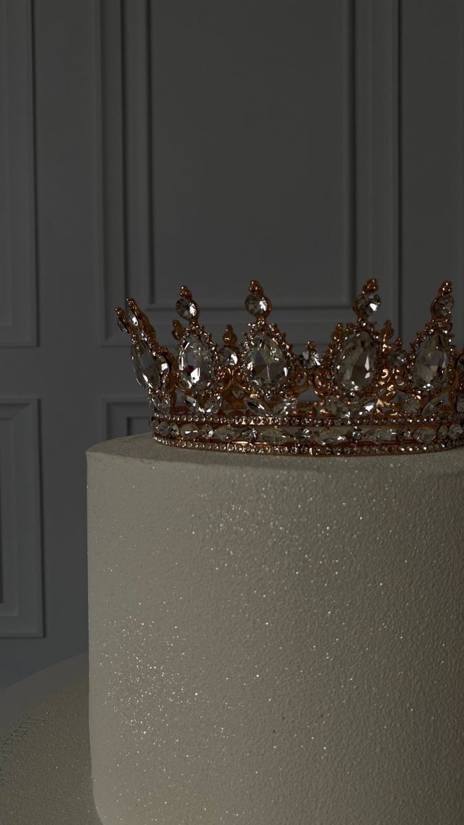 a white cake with a gold crown on top