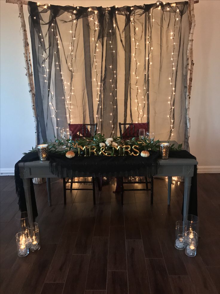 the table is decorated with candles and greenery