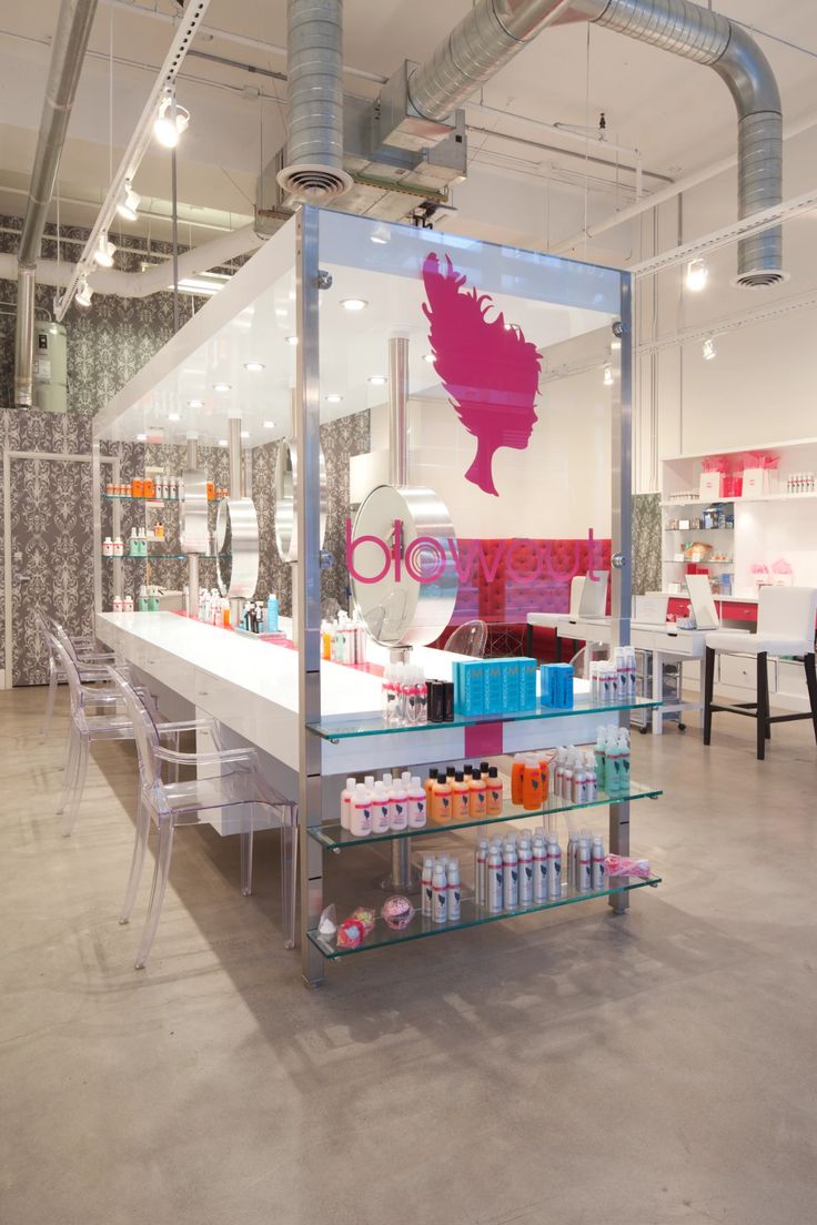 the inside of a store with various items on shelves and chairs in front of it