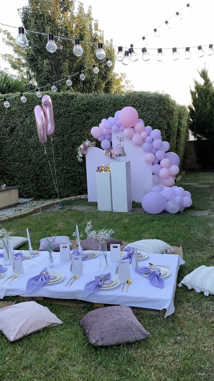 a table set up for a baby shower outside