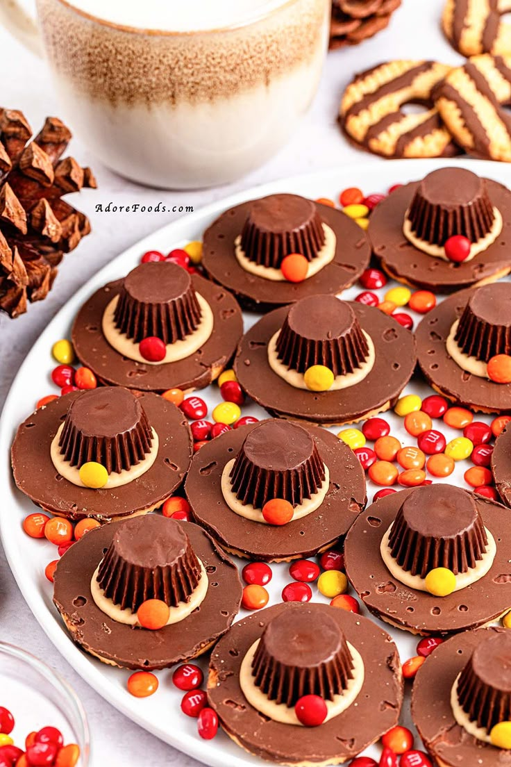 there are many desserts on the plate and one is decorated with chocolate, candy, and candies