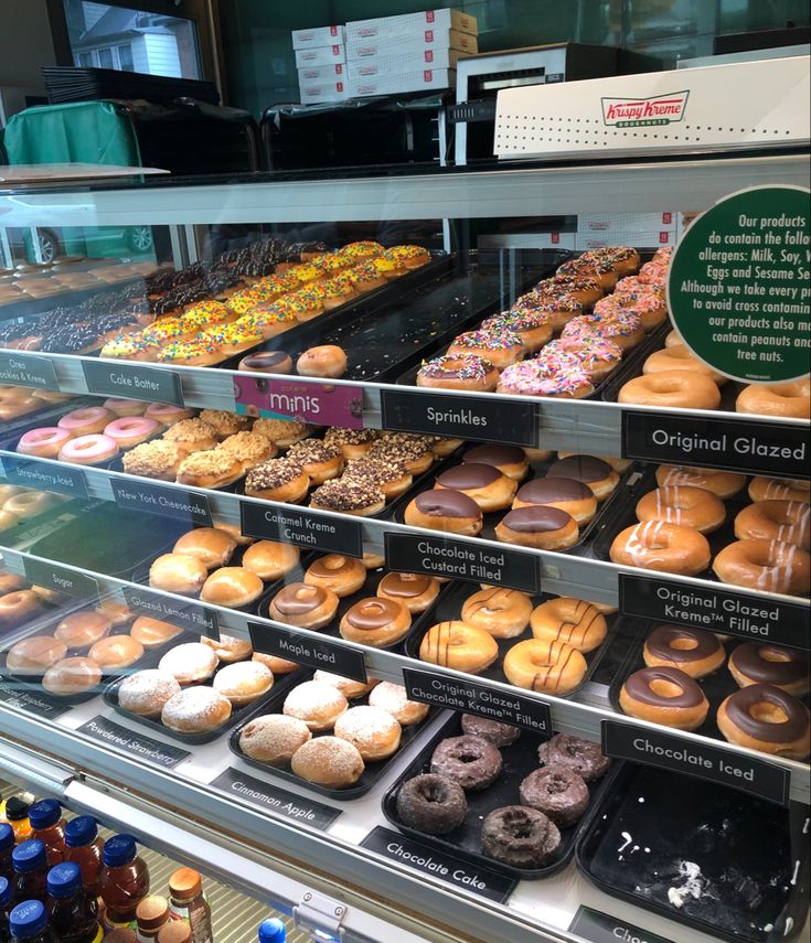 a display case filled with lots of different kinds of doughnuts