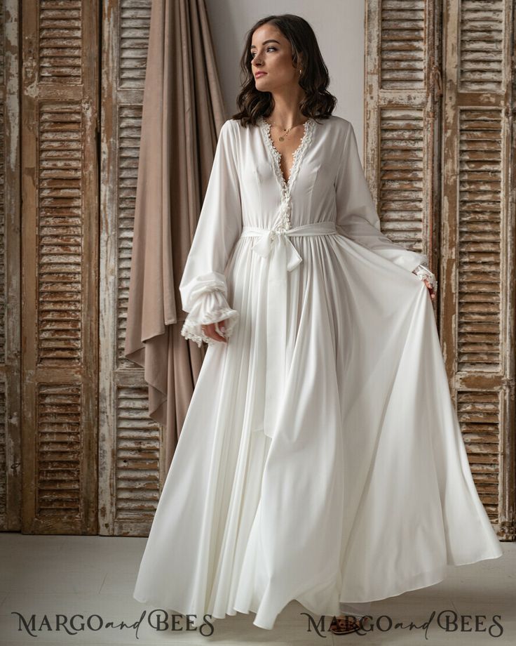 V-neck Lace Trim Nightgown For Wedding, Elegant V-neck Bridal Dress, Elegant Long Sleeve Sleepwear, Elegant White V-neck Nightgown, Feminine Wedding Dress With Satin Finish, Elegant Satin Dresses For Loungewear, Elegant Long Sleeve Sleepwear For Wedding Night, Fitted Satin V-neck Robe, Fitted Satin Robe For Loungewear