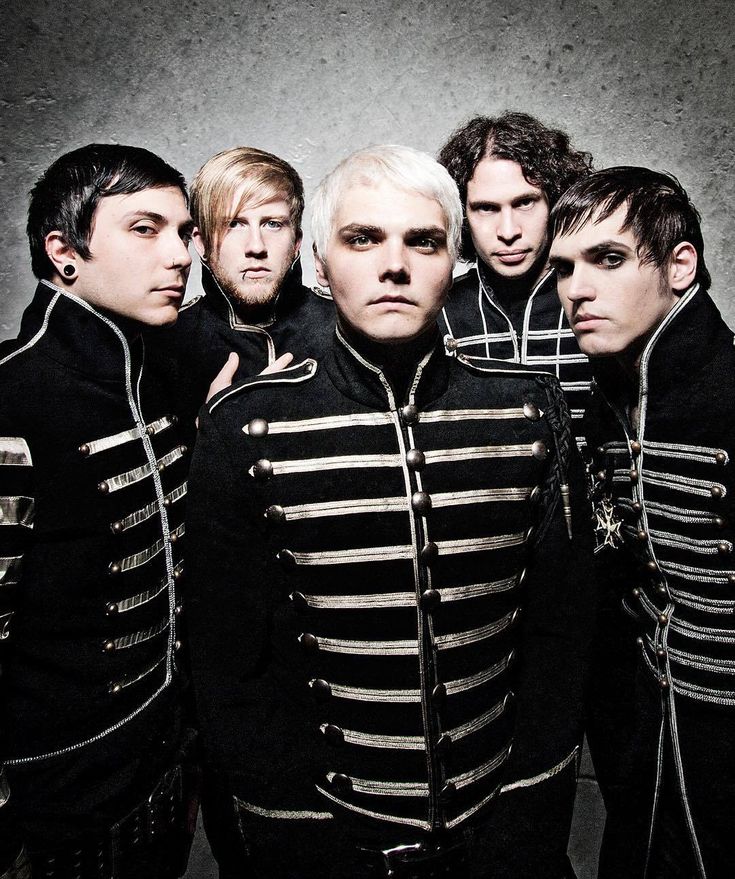 four men in black and silver uniforms posing for a photo together with one man wearing earbuds