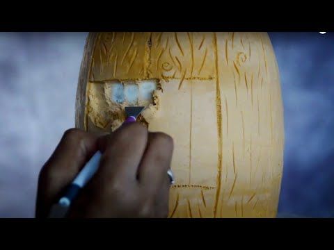 a person is painting a piece of wood