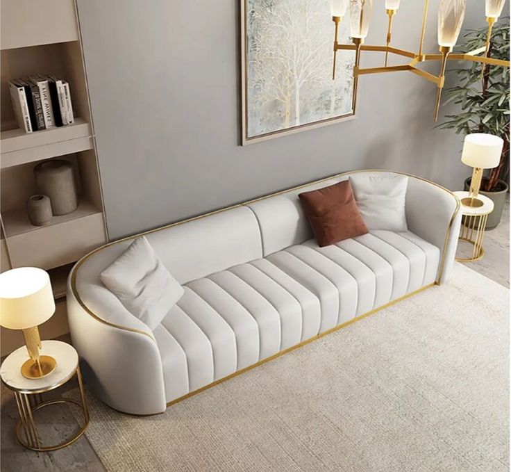 a living room with a white couch and two lamps on either side of the couch