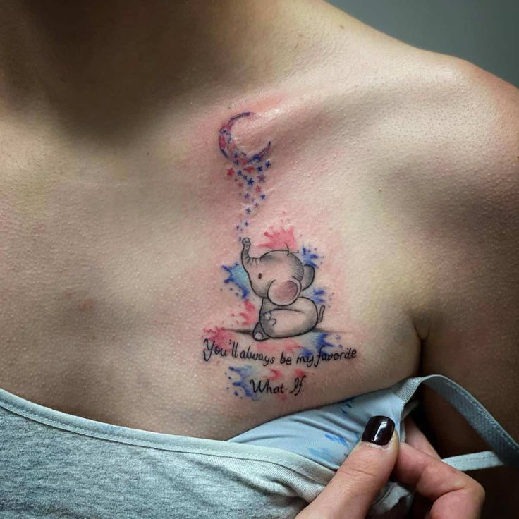 a woman's chest with an elephant tattoo on it