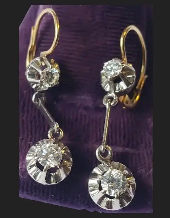 Classic and absolutely beautiful! You can't go wrong with these antique diamond earrings. These will surely be one of your favorites and would make a welcomed addition to your fine collection! From top of hook to the bottom they hang 1 3/8 inches long. The diamond section is 1 1/8 inches long. Diamonds are held in an antique buttercup setting. Bottom diamonds have an approximate width of 4.1 0 mm, so just over a quarter carat each. That setting is 7.90mm wide. Upper ones are about a 0.20 carat each. No hallmarks are present which is common on pieces of such antiquity. Earrings test at 18K gold. The back and upper wire sections are yellow gold. The fronts and bar in the center are white. They have a combined total weight of 5.2 grams. And very good condition. Ready to be worn and admired! P Classic Dangle Diamond Earrings With Accents, Formal Drop Earrings With Diamond Cut, Classic Hallmarked Diamond Earrings For Formal Occasions, Classic Hallmarked Diamond Earrings For Formal Events, Classic Diamond Cut Dangle Earrings, Formal Drop Diamond Earrings With Diamond Cut, Vintage White Gold Diamond Earrings For Formal Events, Formal Dangle Diamond Cut Earrings, Antique Diamond Accent Earrings For Formal Occasions