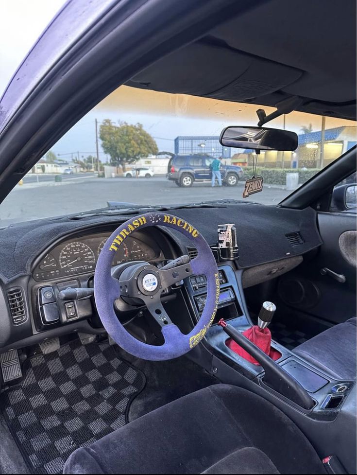 the interior of a car with a steering wheel and dashboard