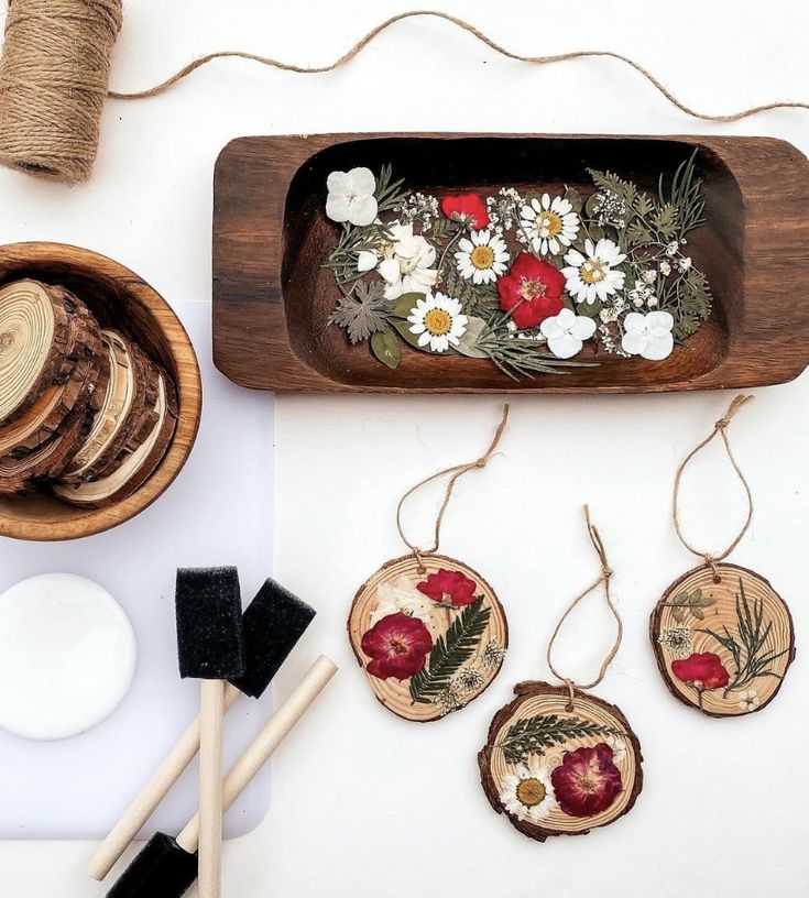 some wood slices with flowers and leaves on them